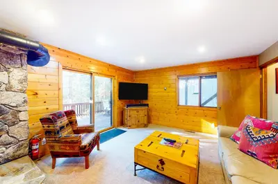 a living room with a couch and a tv at St Bernard Oasis in Truckee