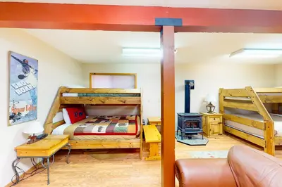 a bedroom with two bunk beds and a couch at St Bernard Oasis in Truckee