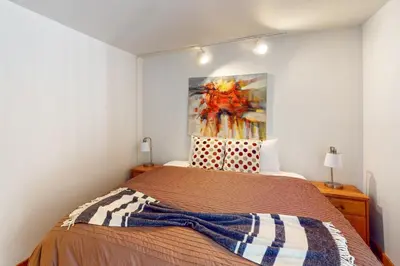 a bedroom with a bed with a painting on the wall at Aspen Grove Escape in Truckee
