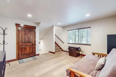 a living room with a couch and a wooden door at Prospector Palace in South Lake Tahoe