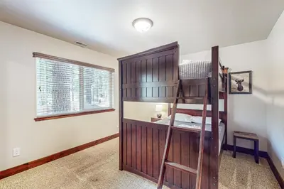 a bedroom with a bunk bed and a window at Prospector Palace in South Lake Tahoe