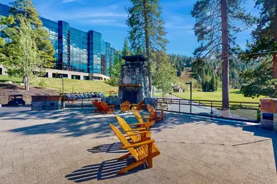 a group of wooden benches sitting in a park at Resort at Squaw Creek's 806 & 808 in Olympic Valley