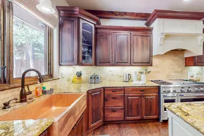 a kitchen with wooden cabinets and a sink at Cochise Charms in South Lake Tahoe