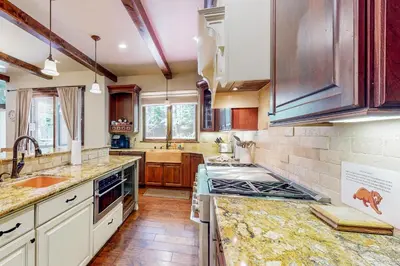 a kitchen with marble counter tops and wooden cabinets at Cochise Charms in South Lake Tahoe