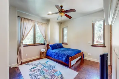 a bedroom with a bed and a ceiling fan at Cochise Charms in South Lake Tahoe