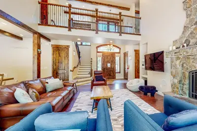 a living room with a leather couch and a fireplace at Cochise Charms in South Lake Tahoe