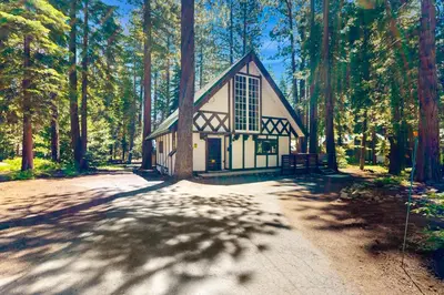 a small building in the middle of a forest at Alpine Haven in Tahoe City