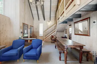 a dining room with a wooden table and blue chairs at Alpine Haven in Tahoe City