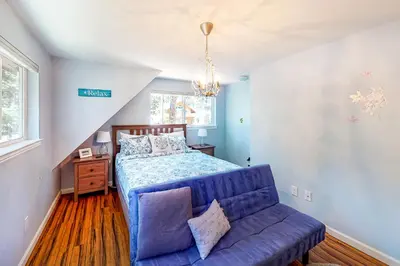 a bedroom with a blue bed and a blue couch at Golden Adventures in Kings Beach