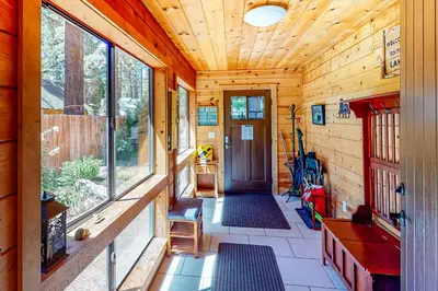 a hallway of a log cabin with a wooden ceiling at Golden Adventures in Kings Beach