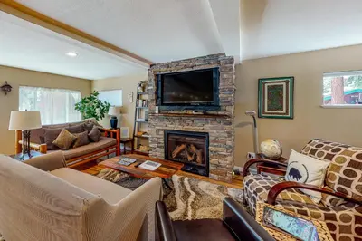 a living room with a fireplace and a tv at Golden Adventures in Kings Beach