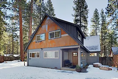 a house with an orange roof in the snow at Golden Adventures in Kings Beach
