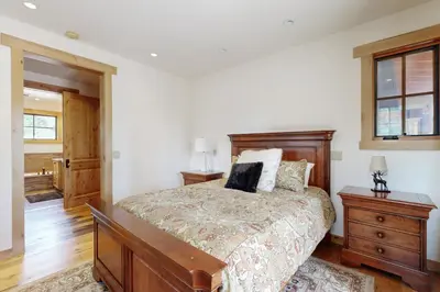 a bedroom with a large bed and a wooden dresser at Mount Olympia Oasis in South Lake Tahoe