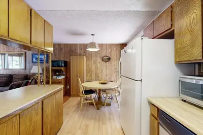 a kitchen with a white refrigerator and a table at Pineland Escape in Tahoe City