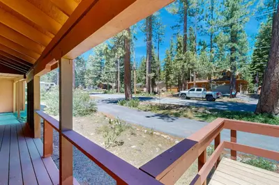 a view from the porch of a house with a truck at Pineland Escape in Tahoe City