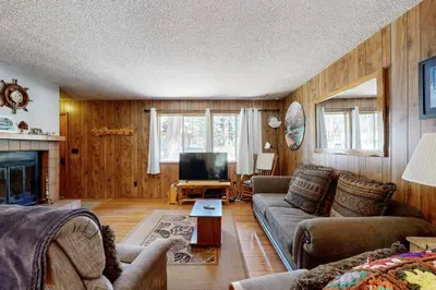 a living room with a couch and a tv at Pineland Escape in Tahoe City