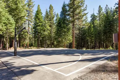 an empty basketball court with trees in the background at Northstar Resort 207 in Truckee