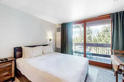 a bedroom with a bed and a large window at Northstar Resort 207 in Truckee