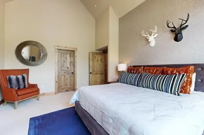a bedroom with a large bed and a chair at Sagebrush Charms in Truckee