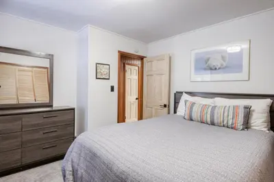 a bedroom with a bed and a dresser and a television at Dodawah Oasis in Carnelian Bay