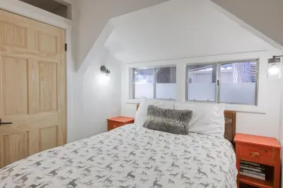 a bedroom with a bed and two windows at Dodawah Oasis in Carnelian Bay