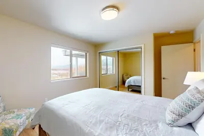 a bedroom with a white bed and a window at Tahoe Keys Haven in South Lake Tahoe