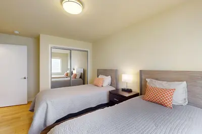 a bedroom with two beds and a mirror at Tahoe Keys Haven in South Lake Tahoe