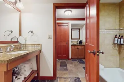 a bathroom with a tub and a sink and a shower at Resort at Squaw Creek's 317 & 319 in Olympic Valley