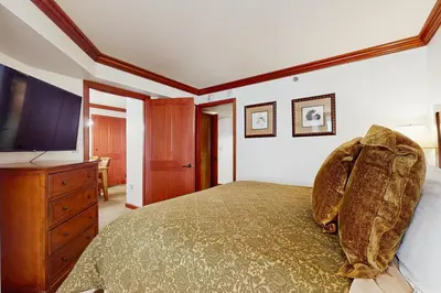 a bedroom with a large bed and a television at Resort at Squaw Creek's 317 & 319 in Olympic Valley