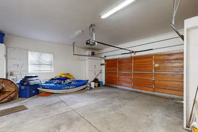 a garage with a boat and a wooden door at Tahoe Donner Snow Globe in Truckee