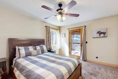 a bedroom with a bed and a ceiling fan at Serenity at Northwoods in Truckee