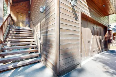 a wooden building with stairs next to a door at Serenity at Northwoods in Truckee