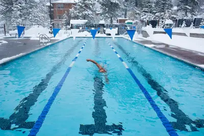 a person swimming in a swimming pool in the snow at Serenity at Northwoods in Truckee