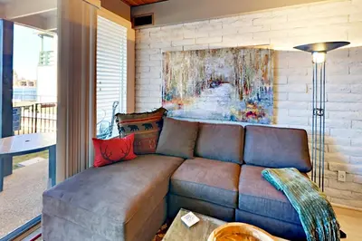 a couch in a living room with a painting on the wall at Cove 141 in South Lake Tahoe