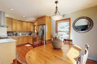 a kitchen with a wooden table with a vase on it at Zermatt Getaway in Truckee