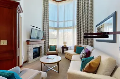a living room with a couch and a fireplace at Resort at Squaw Creek's 810 & 812 in Olympic Valley