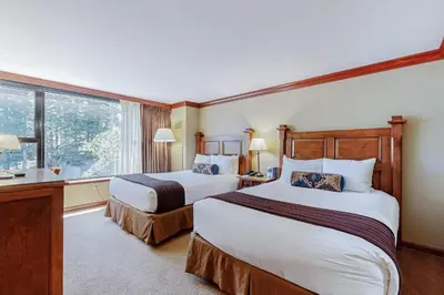 a hotel room with two beds and a window at Resort at Squaw Creek's 605 & 607 in Olympic Valley