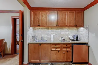 a kitchen with wooden cabinets and a sink at Resort at Squaw Creek's 605 & 607 in Olympic Valley