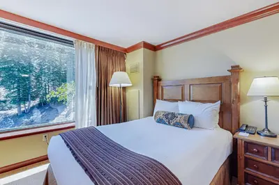 a bedroom with a large bed and a window at Resort at Squaw Creek's 605 & 607 in Olympic Valley
