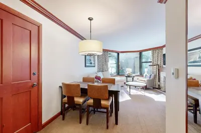 a dining room and living room with a table and chairs at Resort at Squaw Creek's 521 & 523 in Olympic Valley