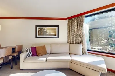 a living room with a couch and a table at Resort at Squaw Creek's 521 & 523 in Olympic Valley