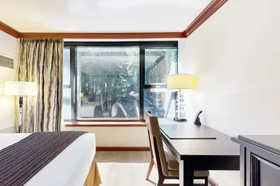a hotel room with a desk and a window at Resort at Squaw Creek's 521 & 523 in Olympic Valley