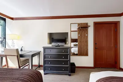 a hotel room with a desk and a bedroom at Resort at Squaw Creek's 521 & 523 in Olympic Valley