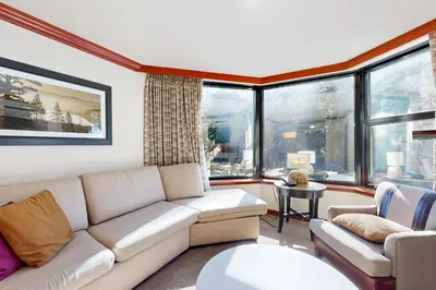 a living room with a couch and windows at Resort at Squaw Creek's 521 & 523 in Olympic Valley