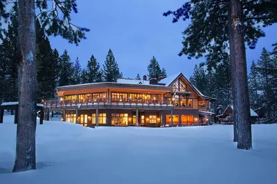 a large house in the snow at night at Pathway Paradise in Truckee
