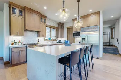 a kitchen with a large island with bar stools at Henness Haven in Truckee