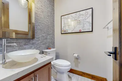 a bathroom with a sink and a toilet and a map at Henness Haven in Truckee