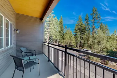 a balcony with two chairs and a view of trees at Walk-Friendly Truckee House in Truckee