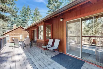 a deck with chairs and windows on a house at High Meadows Retreat in South Lake Tahoe