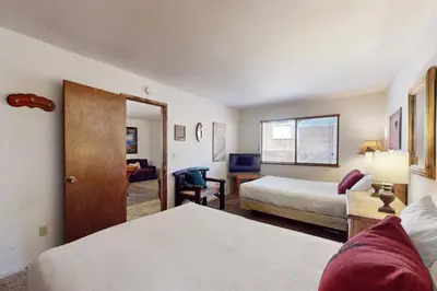 a hotel room with two beds and a door at High Meadows Retreat in South Lake Tahoe